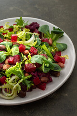 Warm salad with mixed salad with boiled beetroot and beans with spices