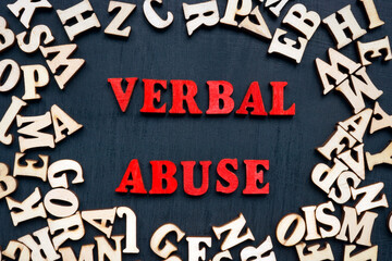 Words verbal abuse and wooden letters around. - obrazy, fototapety, plakaty