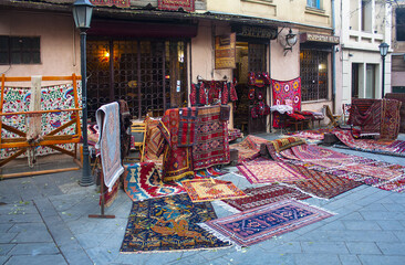 Fototapeta na wymiar Old beautiful decorated carpets in the street market in Tbilisi Old town, Georgia