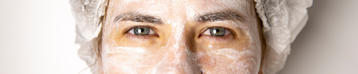 Fototapeta premium Cream mask on the face of the girl, rejuvenating face mask.