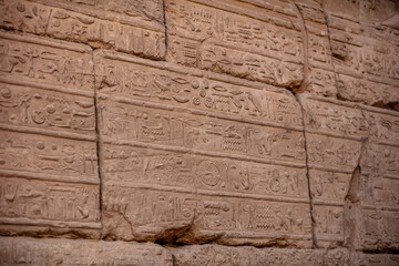 Different hieroglyphs on the walls and columns in the Karnak temple. Karnak temple is the largest complex in ancient Egypt.