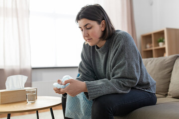 mental health, stress and depression - sad woman popping bubble wrap at home