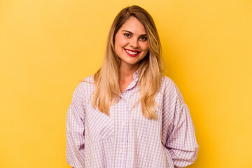 Young caucasian woman isolated on yellow background happy, smiling and cheerful.