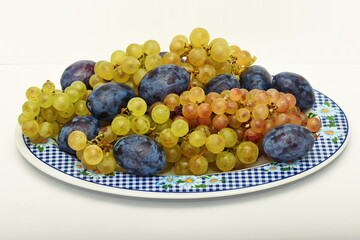  Mixed fruit platter with  yellow pears, grapes, figs and prunes