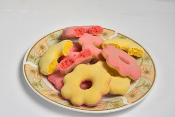 Romanian traditional cakes pink and yellow for Easter on the plate  - pink and yellow gingerbread