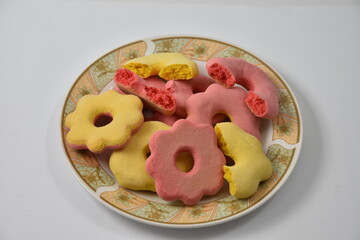 Romanian traditional cakes pink and yellow for Easter on the plate  - pink and yellow gingerbread