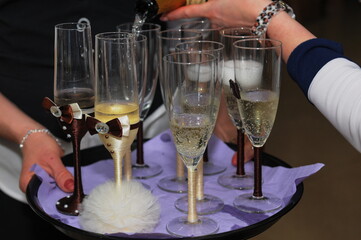 the waiter pours the drink into the glass