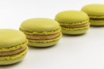 Pistachio Macarons on white background close up.