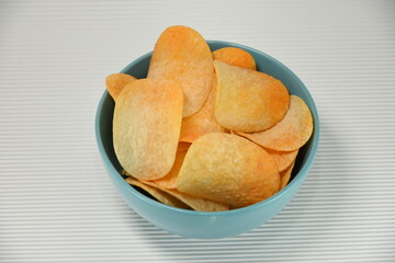 Spicy and flavorful chips, Mexican nacho chips  in a blue porcelain plate