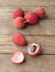 Lychees cut fruit over wooden table