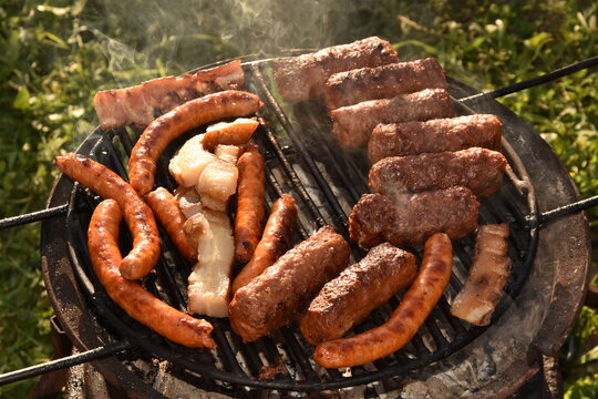 barbecue, spicy sausages and bacon in metal wheell