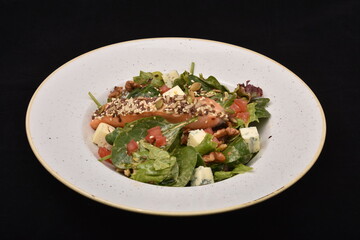 salad with salmon, cheese, and various  sesame seeds