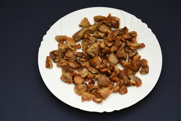 mushrooms fried with goldene apples sliced on a white plate