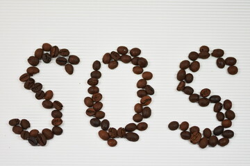 Sign S.O.S. with coffee bean
