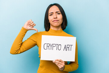 Young hispanic woman holding crypto art placard isolated on blue background feels proud and self confident, example to follow.