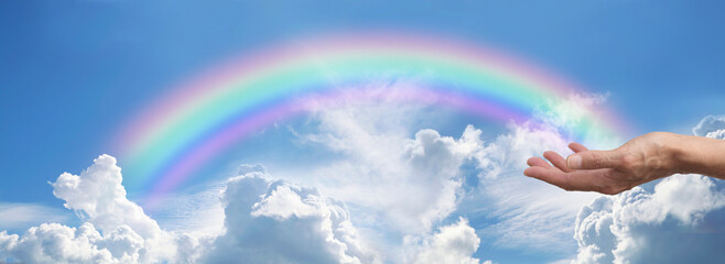 Sending out beautiful rainbow healing energy spiritual background banner - female hand against...
