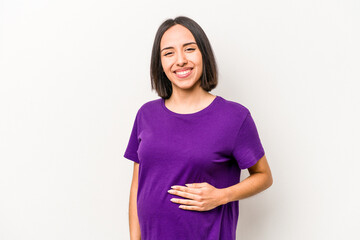 Fototapeta premium Young hispanic pregnant woman isolated on white background laughing and having fun.