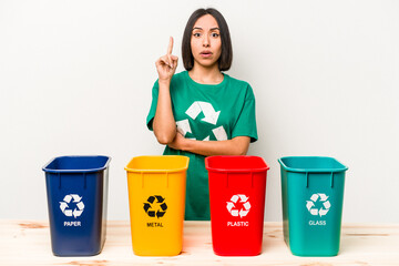 Young hispanic woman recycling isolated on white background having some great idea, concept of creativity.