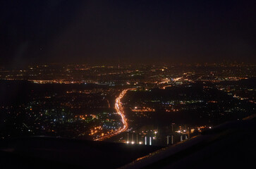 view from the window of the plane on the night city. bird's eye view of city lights at night
