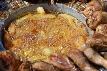  chicken and fried potatoes on a cast iron disk