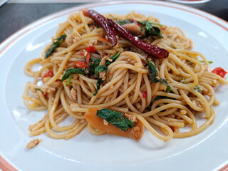 Spaghetti with Spicy pork, sausage and basil.Thai fusion food. side view