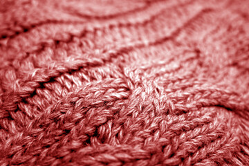 Warm knitting texture with blur effect in red tone.