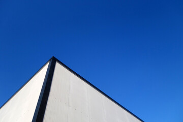 Commercial warehouse aluminium wall and roof against sky.