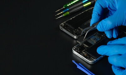 Technician repairing the Cell phone parts and tools for recovery repair phone smartphone and...