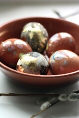 Easter eggs and willow on a white background