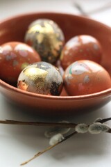 Easter eggs and willow on a white background