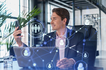Businessman in suit using smart phone to check new candidates for international business...