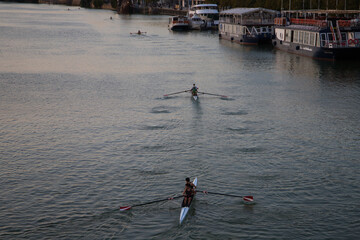 group of canoeists training and competing in the guadalquivir river in seville. They are preparing...