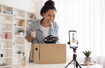 Fototapeta na wymiar Makeup Blogger Woman Making Video On Phone Unpacking Box Indoor