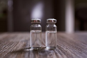 two closed ampoules with a clear liquid without a label