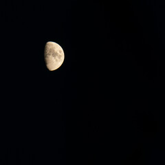 Waxing or waning moon against a clear black sky