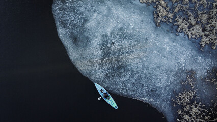 a board with a paddle in winter, top view