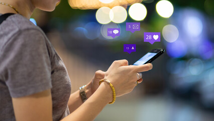 Social Network Concept, woman using the phone to send text messages ,Social media interactions on mobile smartphone , notification icon of likes, messages, email, comments.