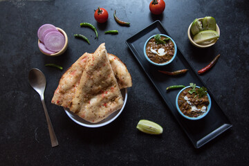 View from top of Indian food item roti or flat bread served along with daal makhni or black lentil soup. 
