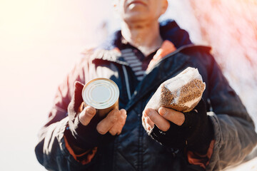 Banner photo humanitarian aid community charity donations center. Homeless refugee is holding box...