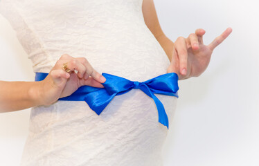 Pregnant woman holding belly