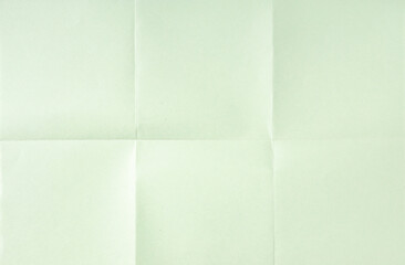 Light green crumpled unfolded paper sheet texture background. Paper folded in six. Full frame