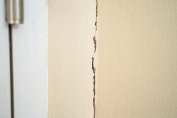 Settlement cracks of cement wall that occur at expansion joints in house structure. - obrazy, fototapety, plakaty