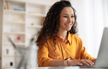 Cheerful Brunette Businesswoman Using Laptop Working In Modern Office