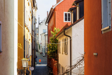 Fototapeta na wymiar Houses and streets with historic residential facades in the Bavarian port city of Lindau on Lake Constance