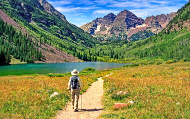 Hiker at Maroon Lake near Aspen, Colorado, with the Maroon Bells in the background