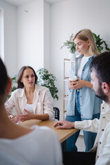 Young coworkers having brainstorming session in modern office