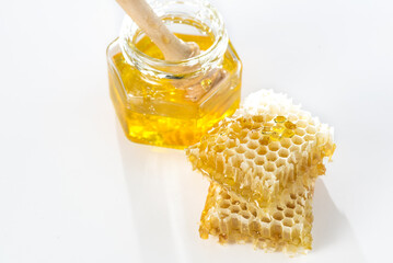 Bee honey and honeycombs close-up on a white background