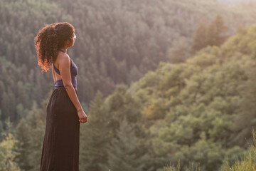 young woman enjoying walk in mountains
