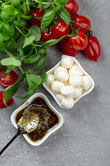 Mozzarella cheese with basil, pesto sauce, and tomatoes.