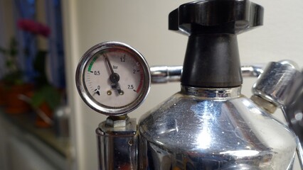 The pressure gauge of an Italian coffee machine.